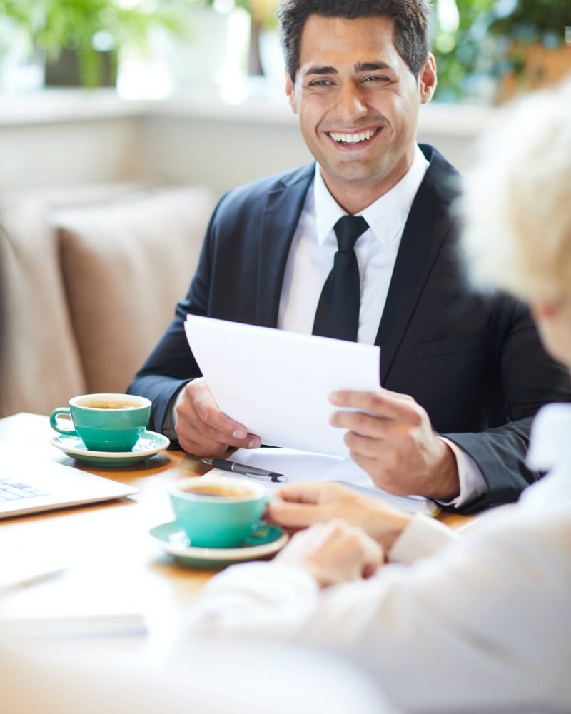 cheerful-lawyer-talking-to-client-in-cafe